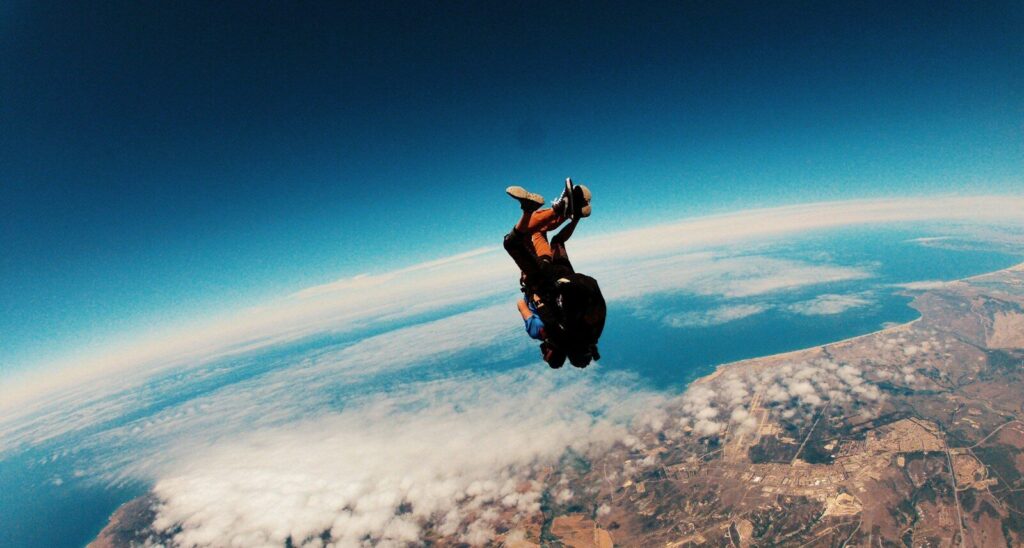 person skydiving on air during daytime